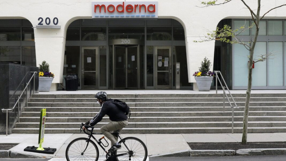 A bicyclists pedals past an entrance to a Moderna, Inc., building, Monday, May 18, 2020, in Cambridge, Mass. Moderna announced Monday that an experimental vaccine against the coronavirus showed encouraging results in very early testing, triggering hoped-f